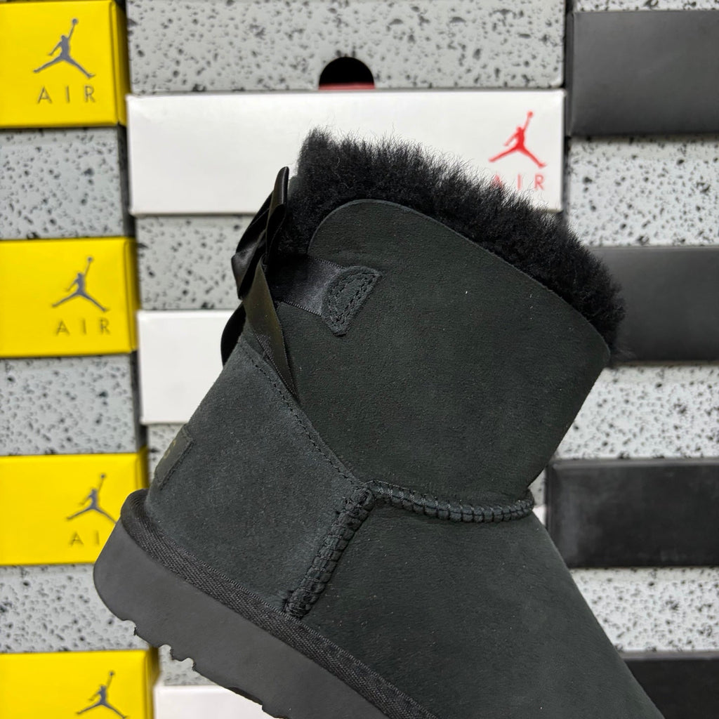 UGG Mini Bailey Bow Ankle Boot – Suede Boot with Tonal Black Shearling Lining, Black Satin Bow & All-Black Lug Sole in Black